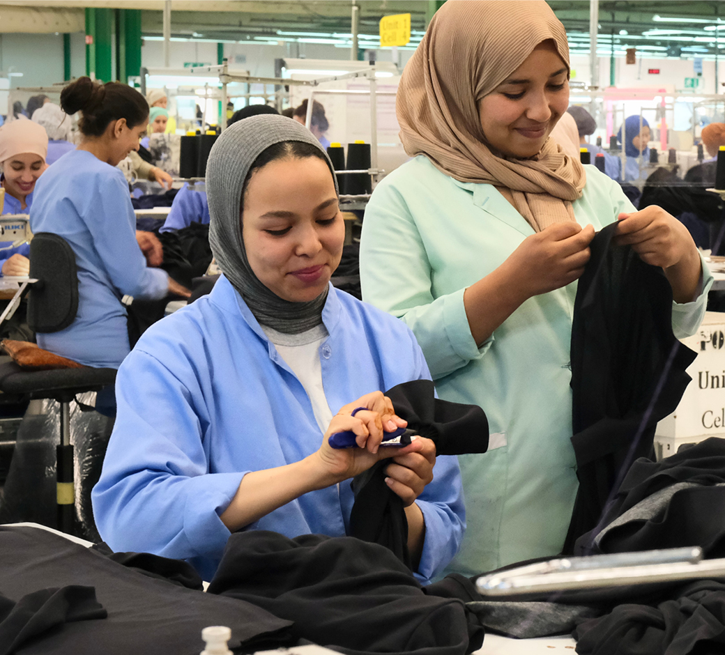 Two women labelling Fruit of the Loom Original Polo Shirts